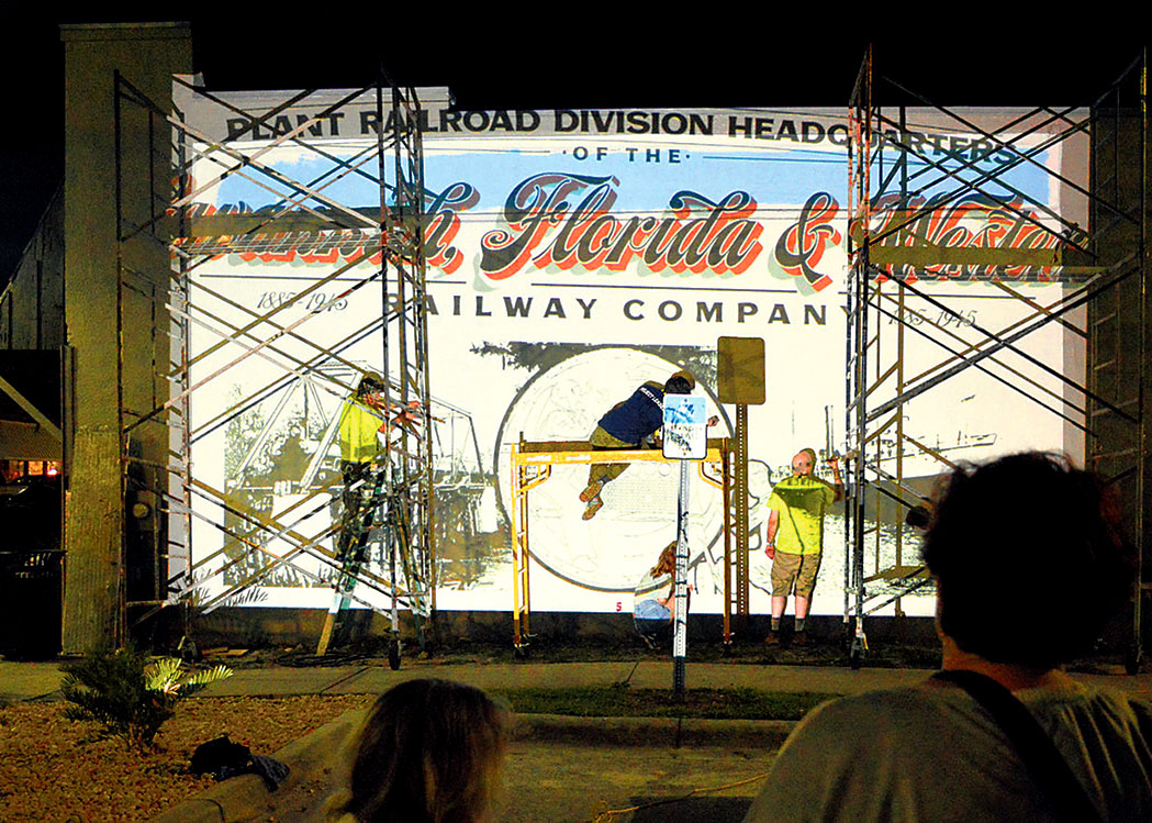 Photo by VIVIAN ARNDT/Artists from Scotland begin projecting images on to walls on the first night of painting.