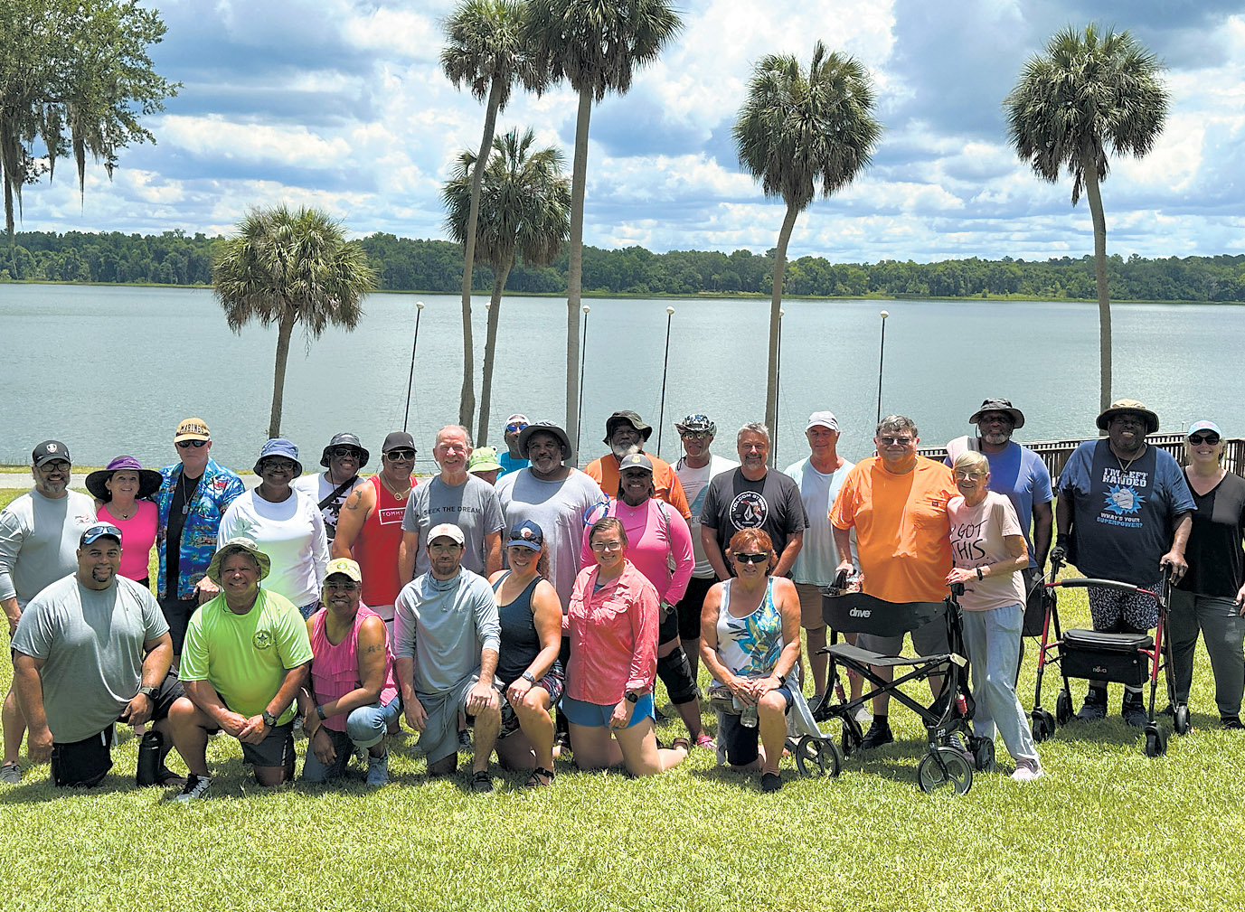Veterans attending an Adaptive Sports Program event at the north shore of Lake Wauburg in Micanopy, where Veterans were able to take part in paddle boarding, kayaking, pedal boating, and canoeing, June 12, 2024, pose for a group photo at the end of the day’s activities / Photo special to Alachua County Today