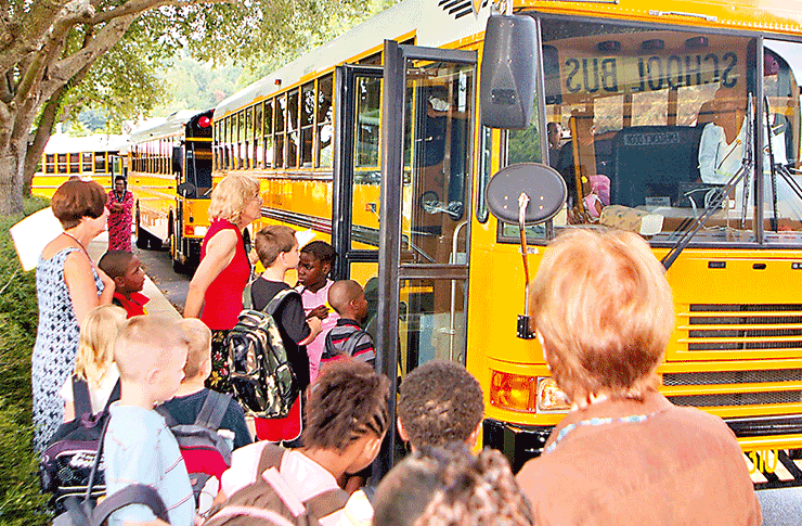 THEN — August 2008: Students line up at the bus loop at Mebane Middle School in Alachua on the first day of the 2008-09 school year. The warm afternoon sun and chatter of friends marked the end of the first day — a scene that remains familiar more than a decade later. / Alachua County Today file photo