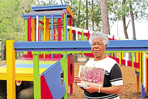 Lee stands in front of the jungle gym that still stands from days   just after she opened Lee’s Preschool and Nursery Center.